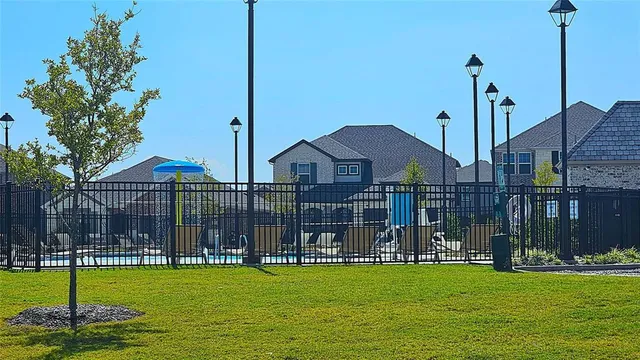 a view of a fountain with a house in the background