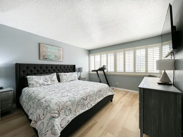 a bed room with a bed window and a television