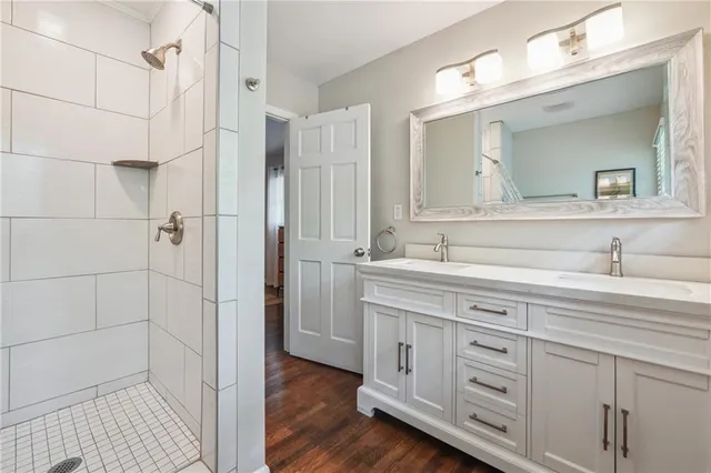 a spacious bathroom with double sink and a mirror
