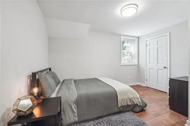 a bedroom with a bed and wooden floor