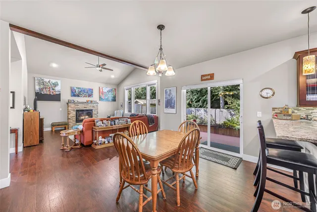 a dining room with furniture window and wooden floor