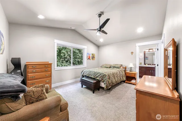 a bedroom with a bed a couch and dresser