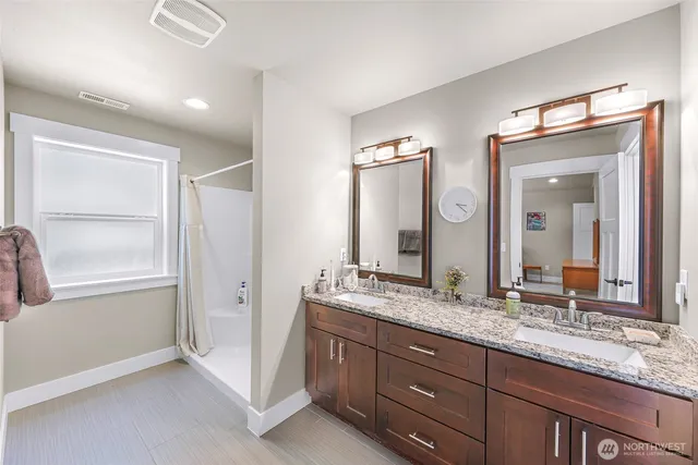 a bathroom with a granite countertop sink and a mirror