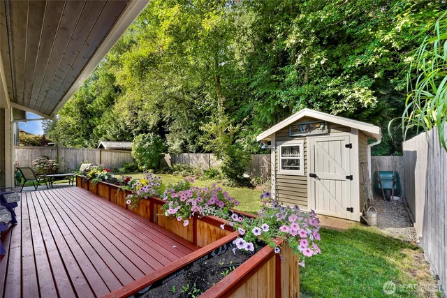 a view of a wooden deck with a yard