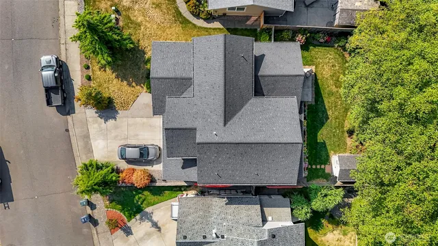 an aerial view of a house with a yard basket ball court and outdoor seating