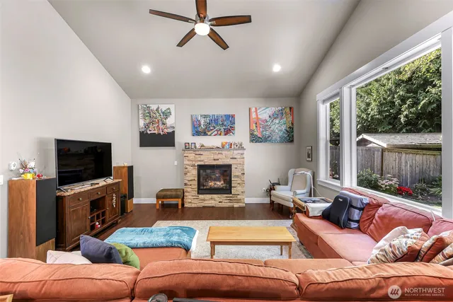 a living room with furniture a fireplace and a flat screen tv