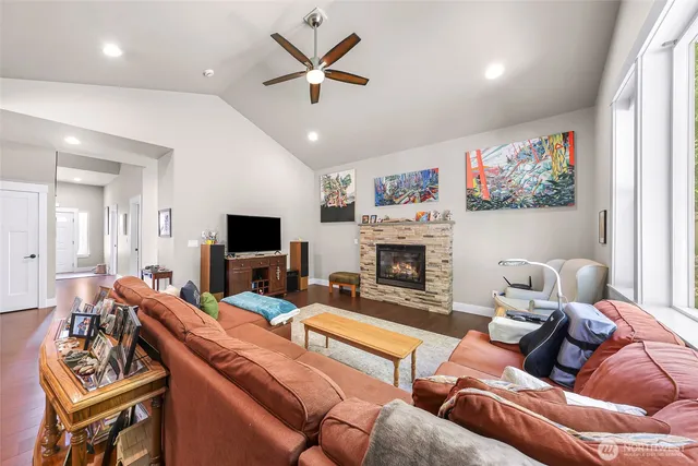 a living room with furniture a fireplace and a flat screen tv