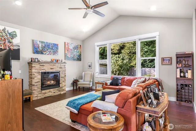 a living room with furniture a fireplace and a large window