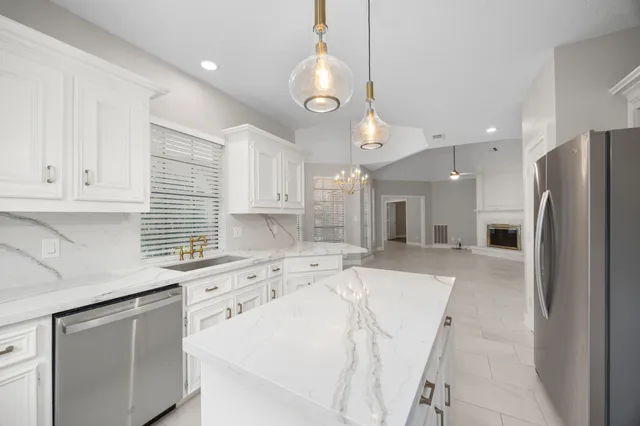 a kitchen with a sink stainless steel appliances and cabinets