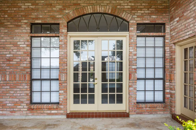 a view of a brick house with a large window