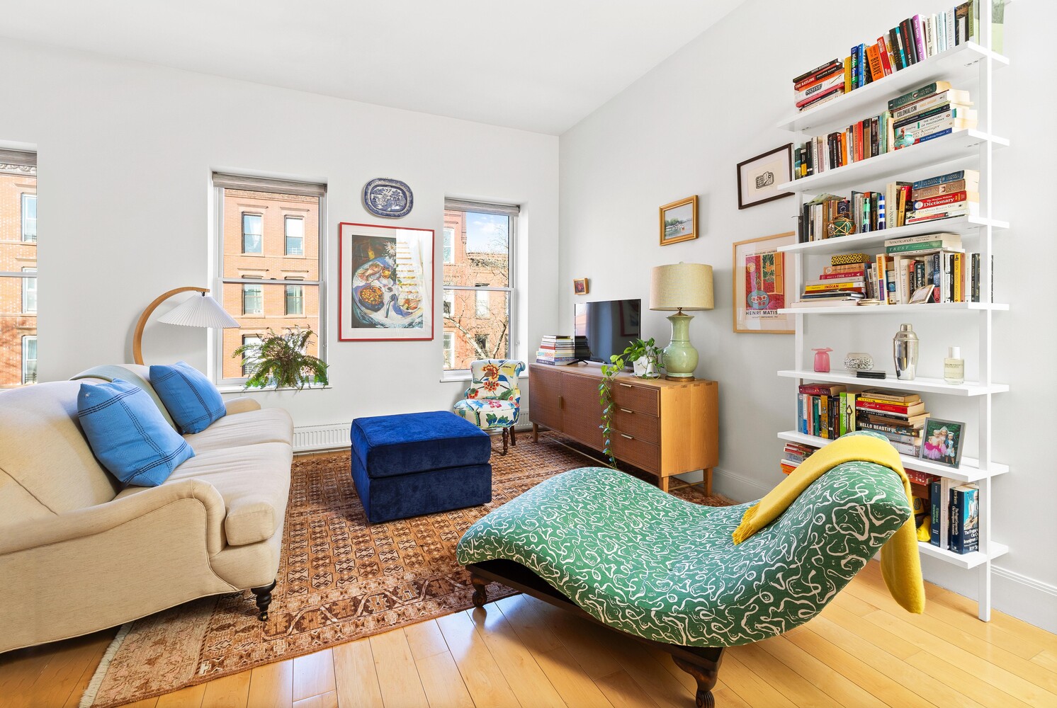 a living room filled with furniture and a book shelf