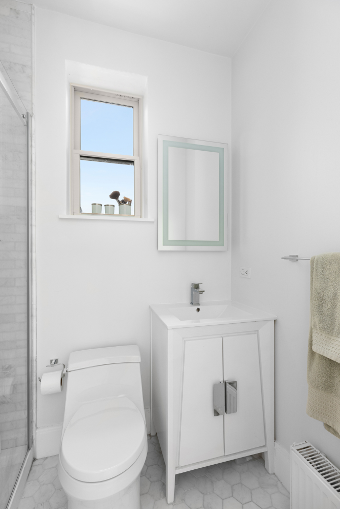 541 Henry Street, Unit D Brooklyn, NY 11231 - Photo 9 of 11 a white toilet sitting next to a bathroom sink