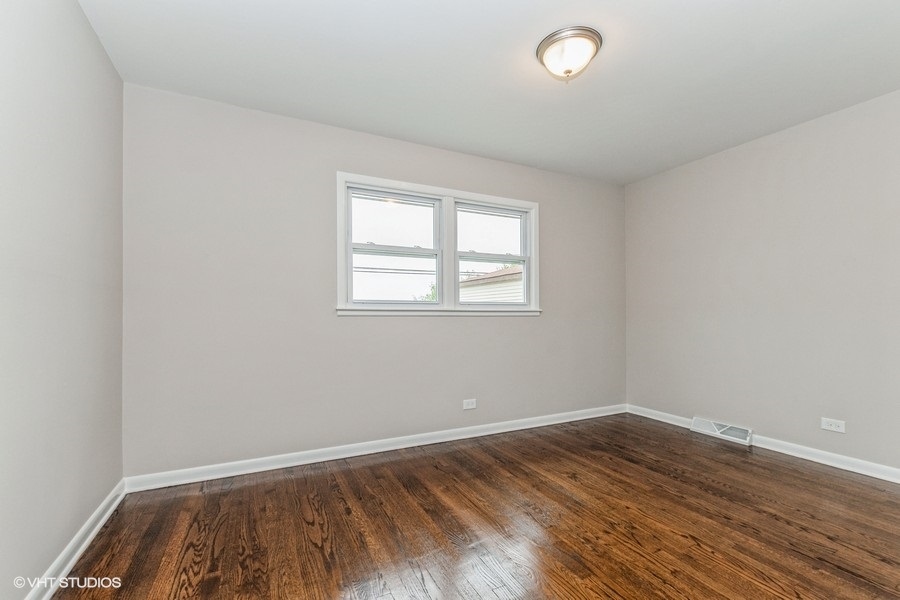 3914 153rd Street Midlothian, IL 60445 - Photo 13 of 17 an empty room with wooden floor and windows