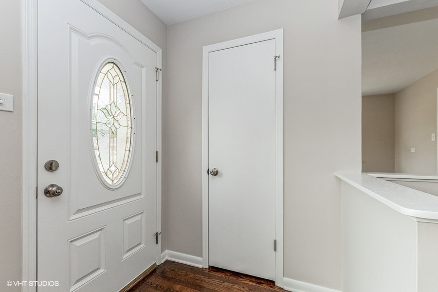 3914 153rd Street Midlothian, IL 60445 - Photo 3 of 17 a view of empty room with wooden floor and mirror