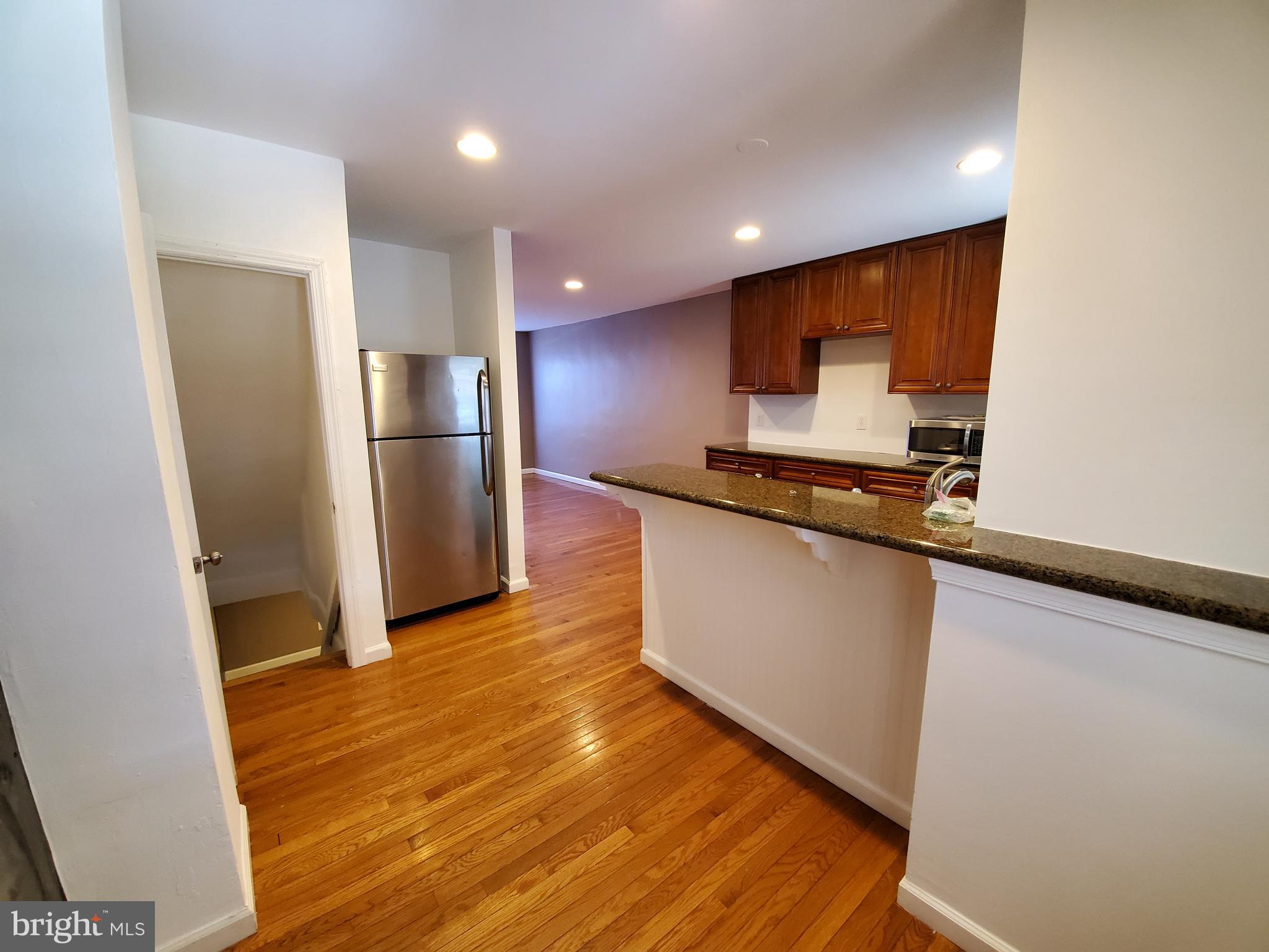 309 Arden Road West Baltimore, MD 21225 - Photo 7 of 16 a kitchen with stainless steel appliances a refrigerator sink and microwave