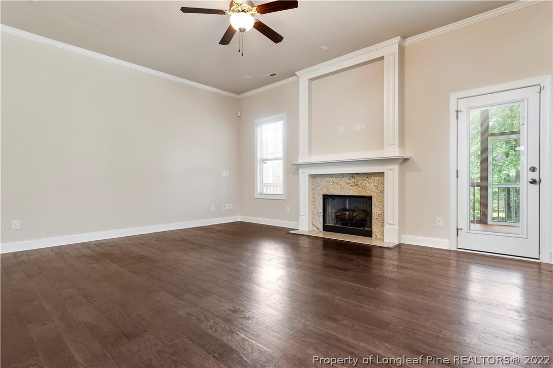 303 Falling Water Road Spring Lake, NC 28390 - Photo 12 of 33 a view of an empty room with wooden floor fireplace and a window