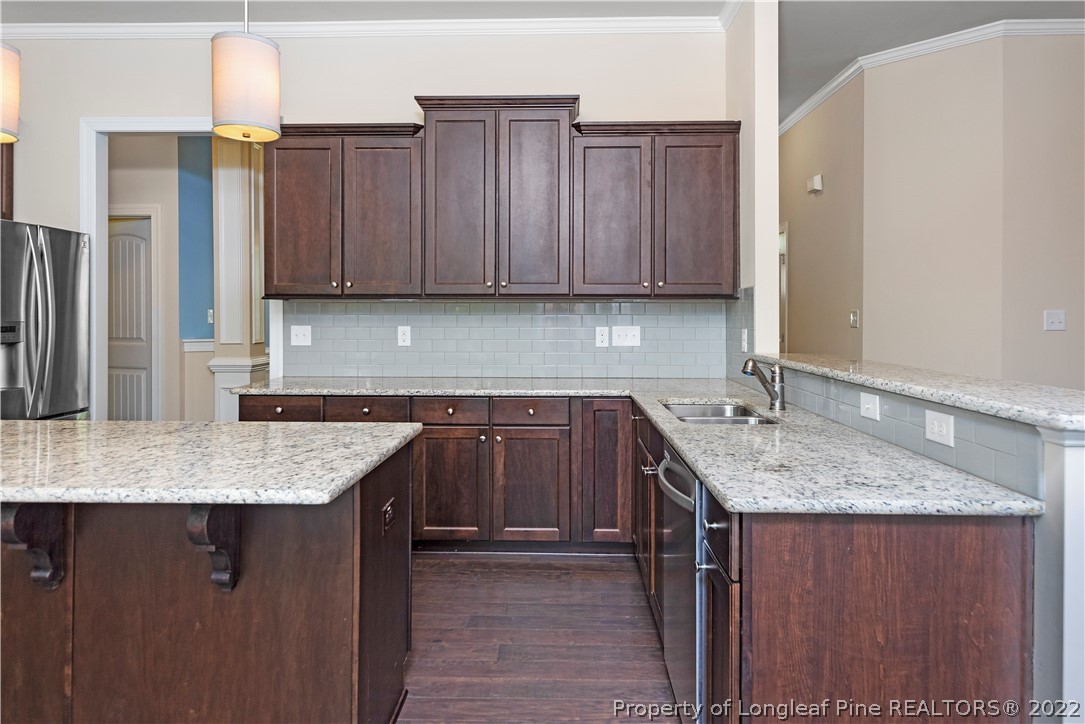 303 Falling Water Road Spring Lake, NC 28390 - Photo 15 of 33 a kitchen with stainless steel appliances granite countertop a sink stove and cabinets