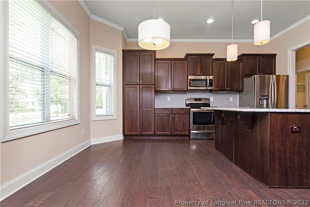 303 Falling Water Road Spring Lake, NC 28390 - Photo 19 of 33 a kitchen with stainless steel appliances granite countertop a refrigerator a sink dishwasher a stove and a oven with wooden floor