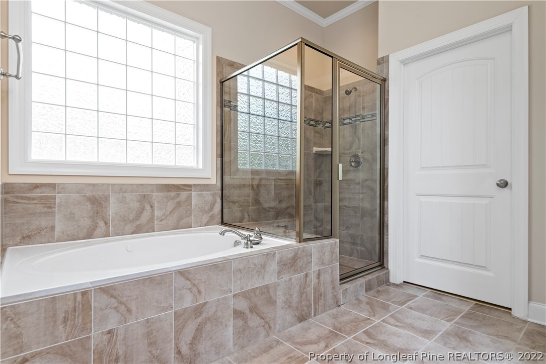 303 Falling Water Road Spring Lake, NC 28390 - Photo 23 of 33 a bathroom with a bathtub and a shower