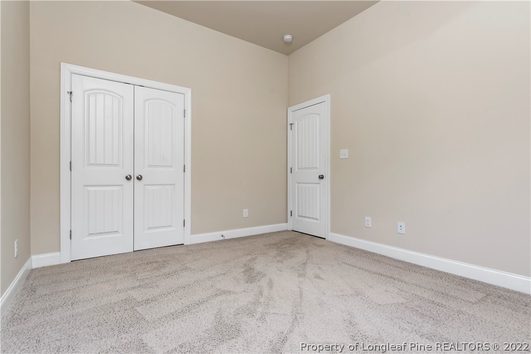 303 Falling Water Road Spring Lake, NC 28390 - Photo 28 of 33 an empty room with white cabinet and mirror