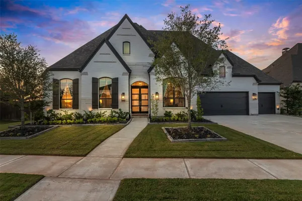 a front view of house with yard and green space