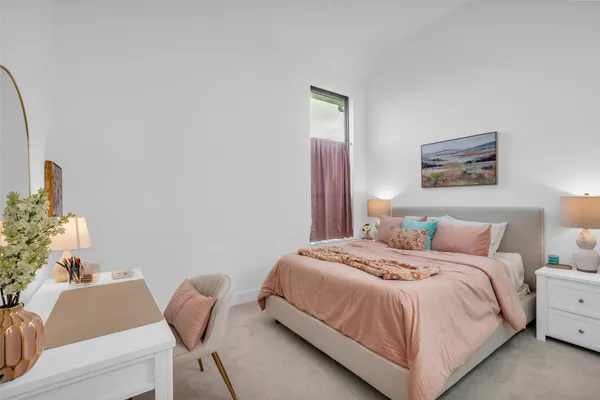 a bedroom with a bed and a table in it