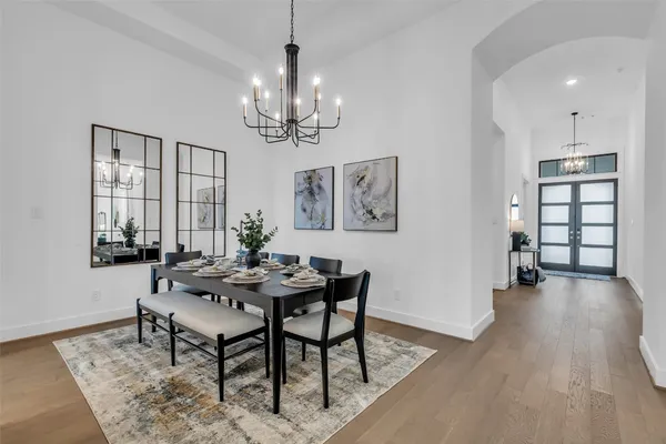 a kitchen with a dining table chairs stainless steel appliances and cabinets