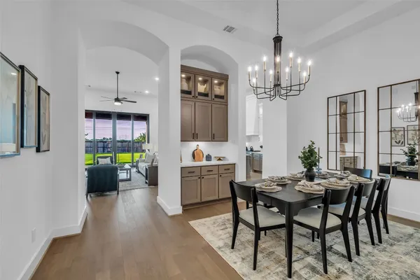 a living room with furniture a flat screen tv and a floor to ceiling window