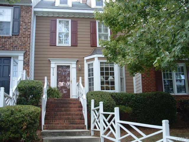 6729 Queen Annes Drive Raleigh, NC 27613 - Photo 1 of 9 a front view of a house with plants and trees