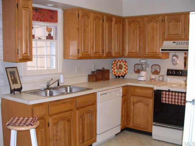 6729 Queen Annes Drive Raleigh, NC 27613 - Photo 4 of 9 a kitchen with stainless steel appliances granite countertop a sink stove and cabinets