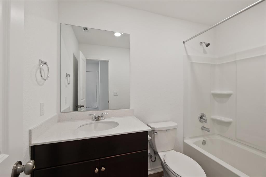 12213 Rising Moon Lane Del Valle, TX 78617 - Photo 10 of 11 a bathroom with a sink toilet a mirror and shower