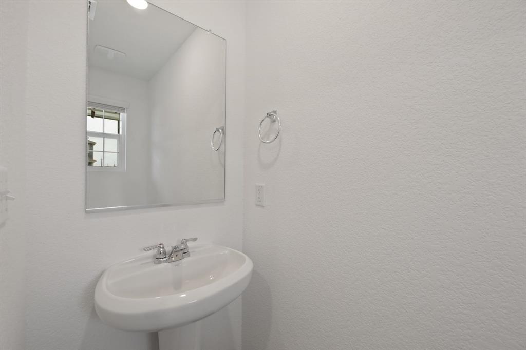 12213 Rising Moon Lane Del Valle, TX 78617 - Photo 5 of 11 a bathroom with a sink and a mirror