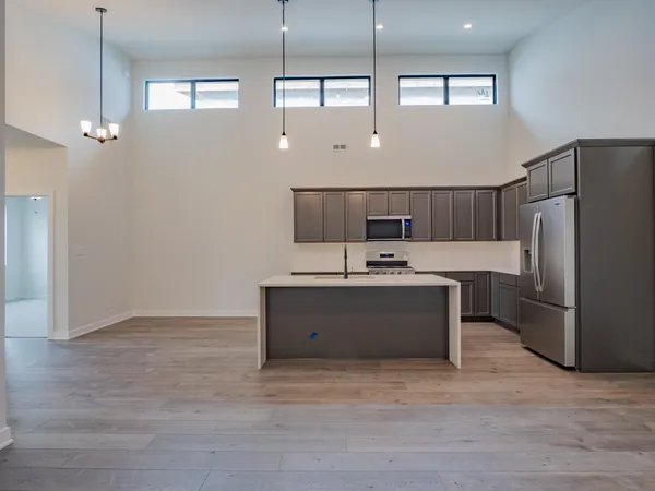 a large room with a lot of cabinets and wooden floor