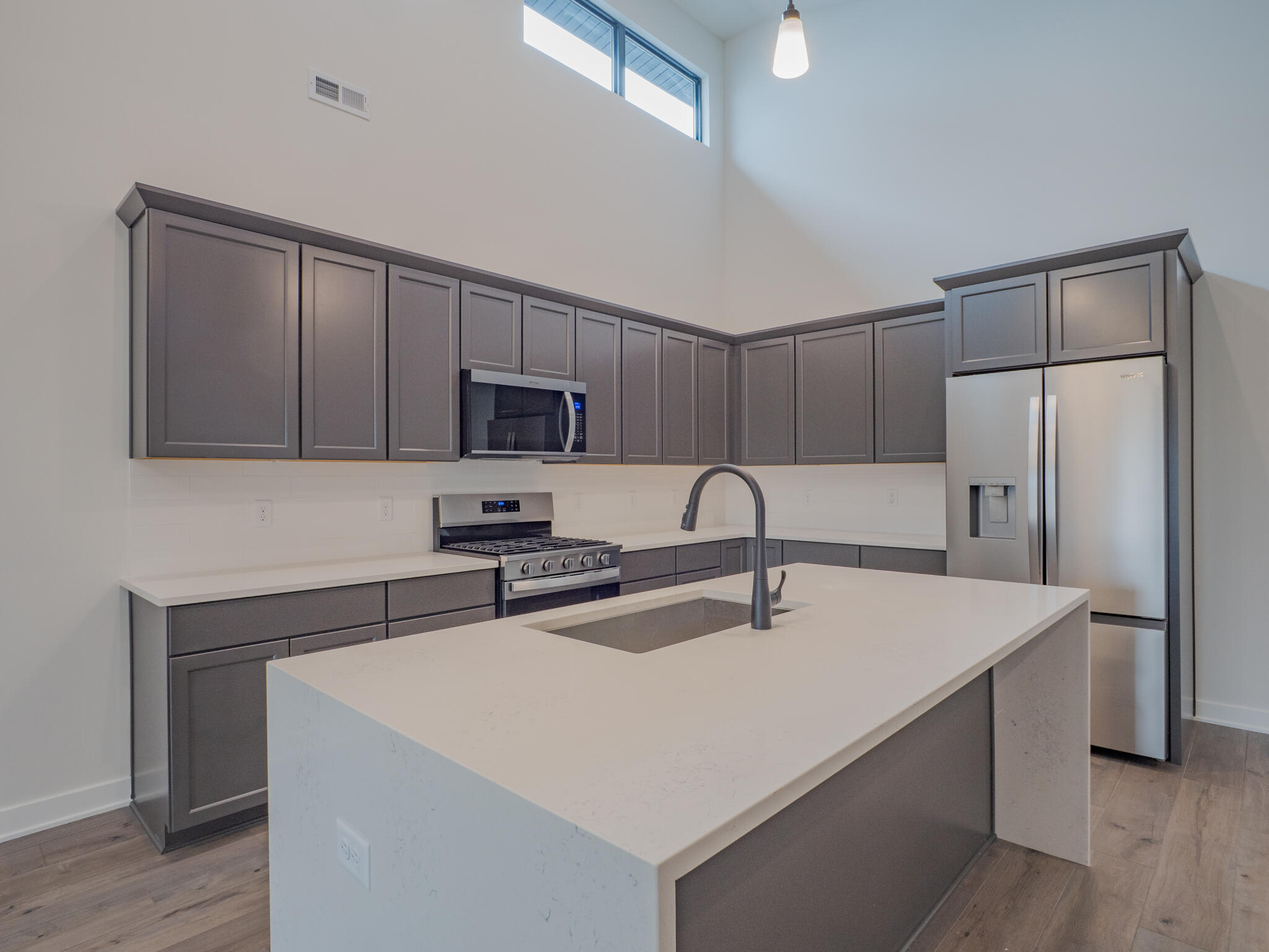 244 Sawgrass Drive Crown Point, IN 46307 - Photo 6 of 19 a kitchen with stainless steel appliances a sink a stove a refrigerator a center island and cabinets