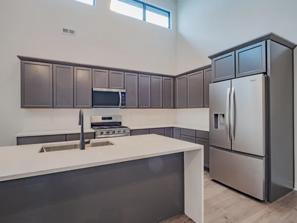 a kitchen with a sink and cabinets
