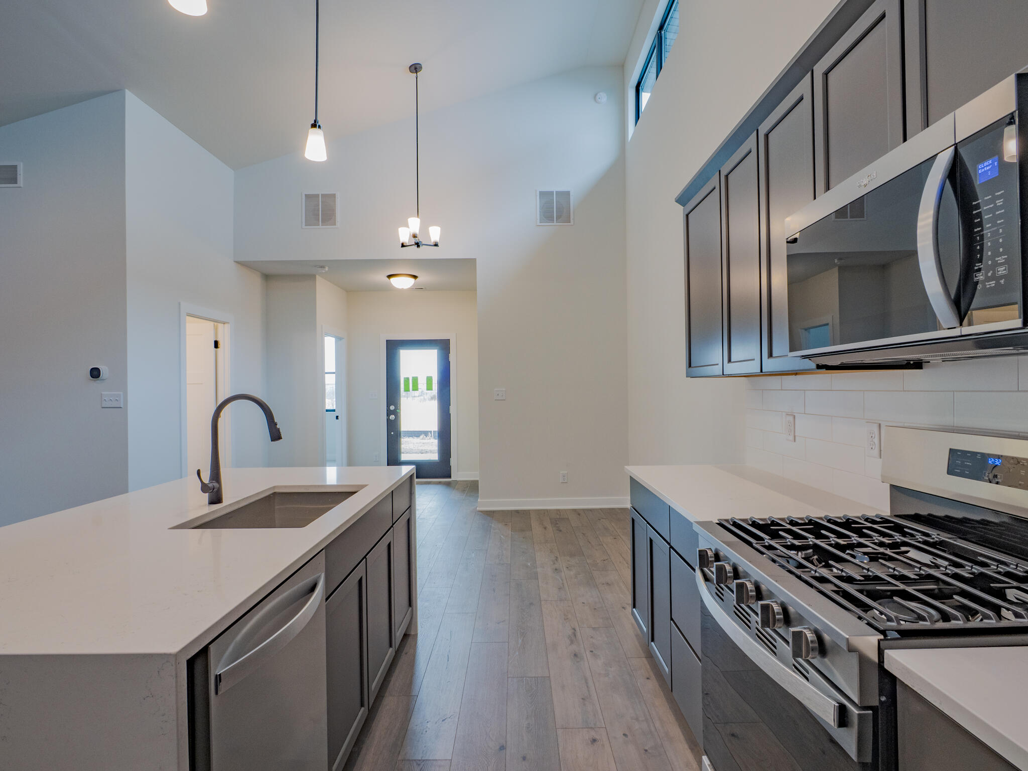 244 Sawgrass Drive Crown Point, IN 46307 - Photo 9 of 19 a kitchen with stainless steel appliances granite countertop a sink a stove and a wooden floors