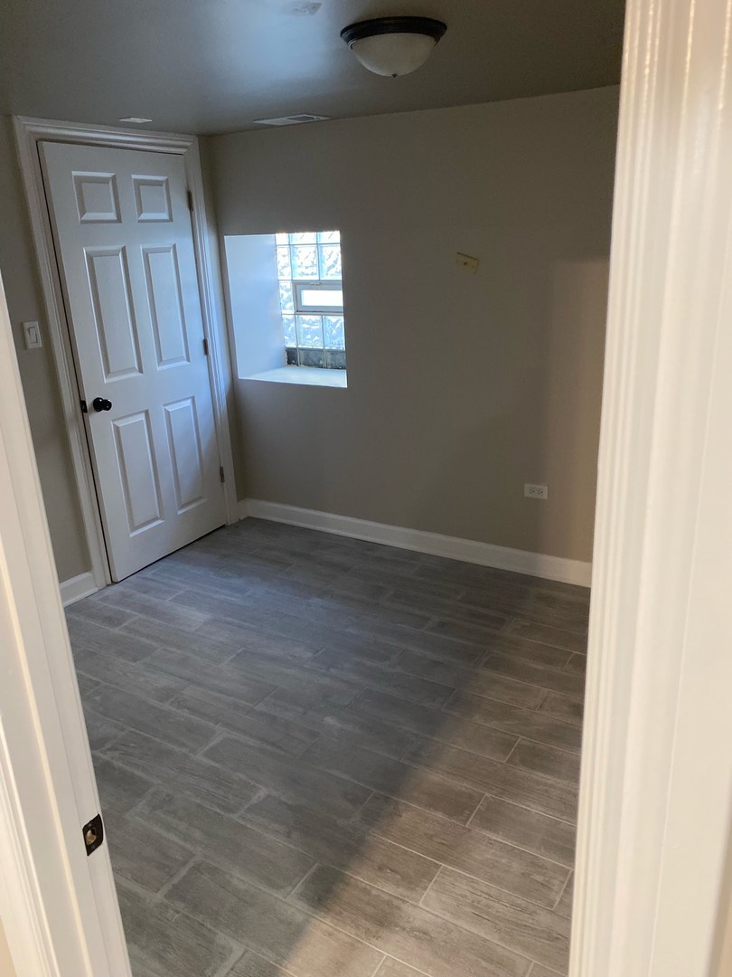2122 North Keystone Avenue, Unit G Chicago, IL 60639 - Photo 2 of 4 an empty room with windows