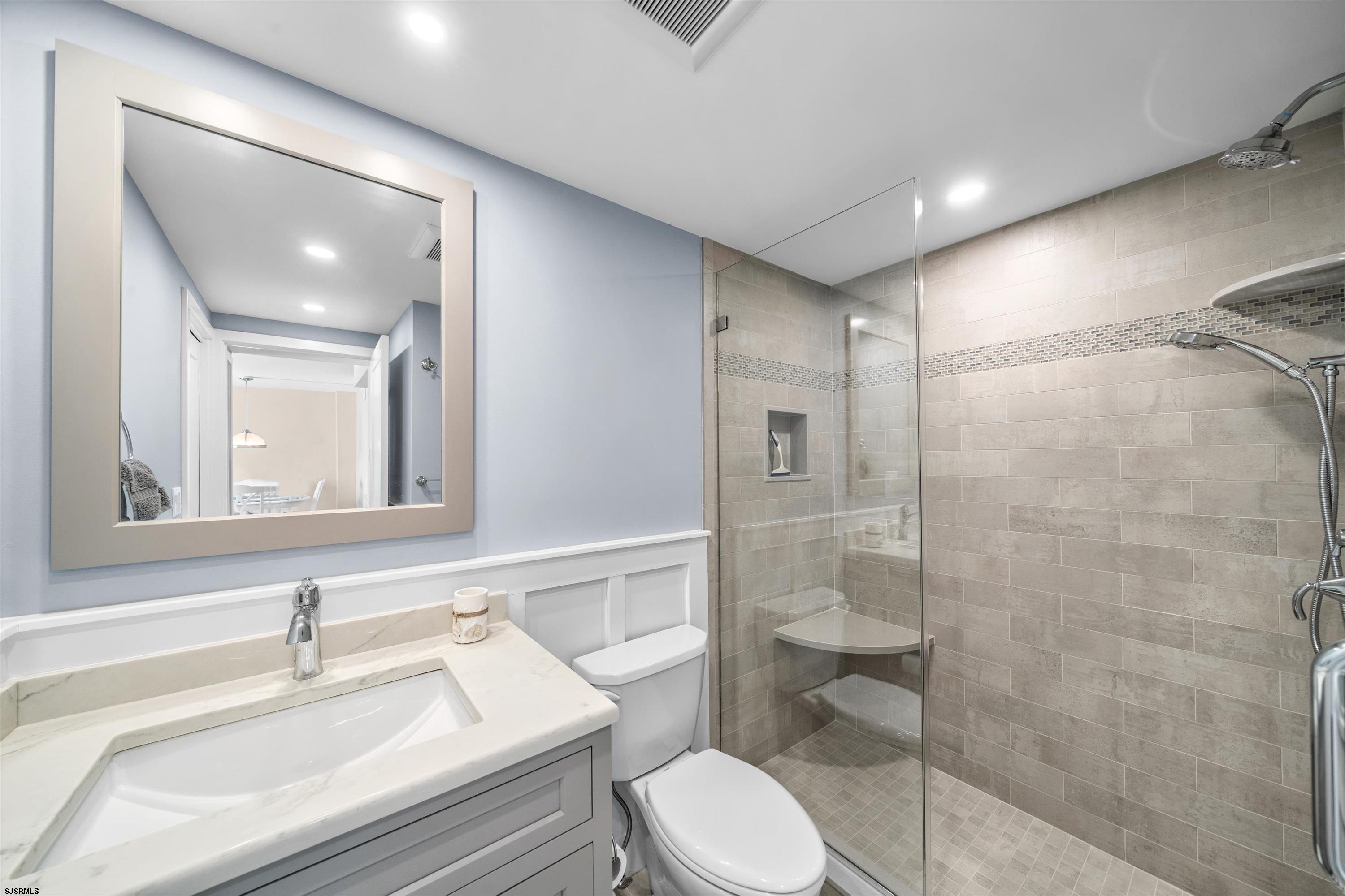 322 Boardwalk, Unit 1007 Ocean City, NJ 08226 - Photo 14 of 27 a bathroom with a sink a toilet and shower