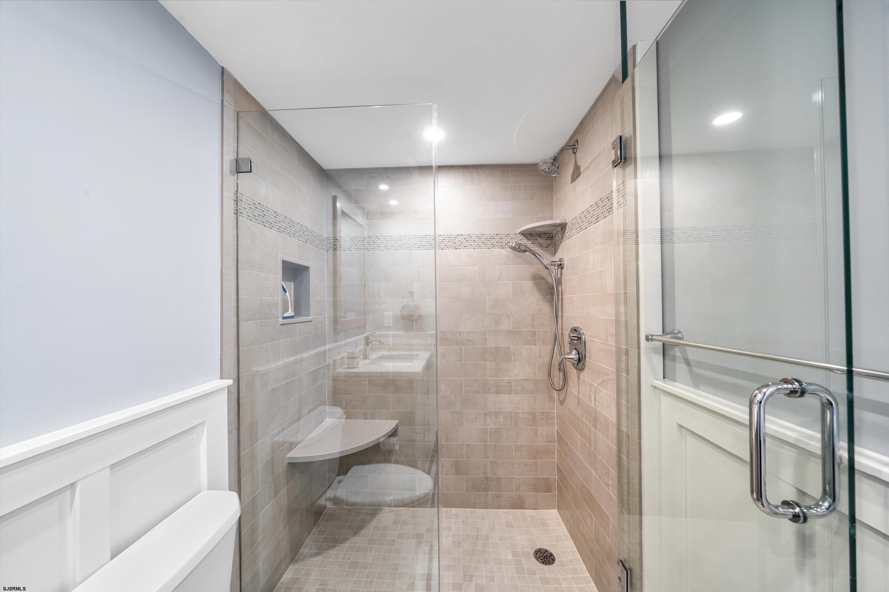 322 Boardwalk, Unit 1007 Ocean City, NJ 08226 - Photo 15 of 27 a bathroom with a shower and toilet