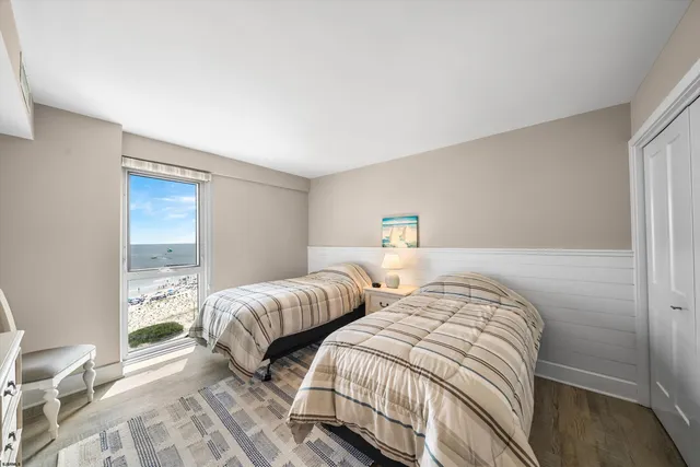 a bedroom with two beds and a window