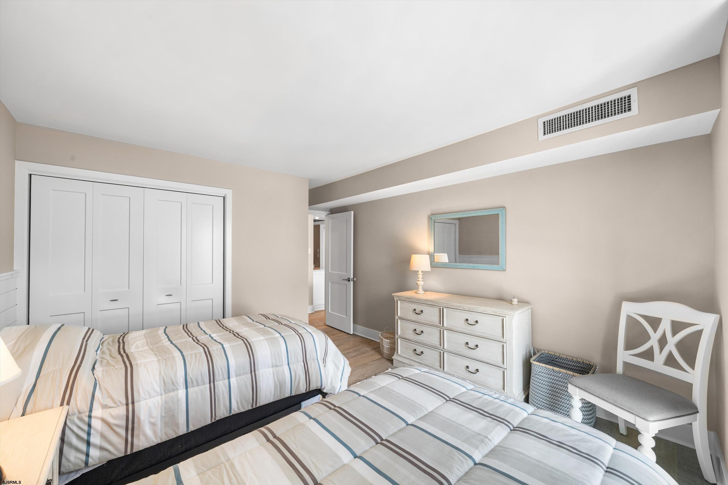 322 Boardwalk, Unit 1007 Ocean City, NJ 08226 - Photo 17 of 27 a bedroom with a bed and a couch