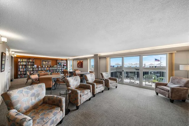 a living room with furniture and a floor to ceiling window