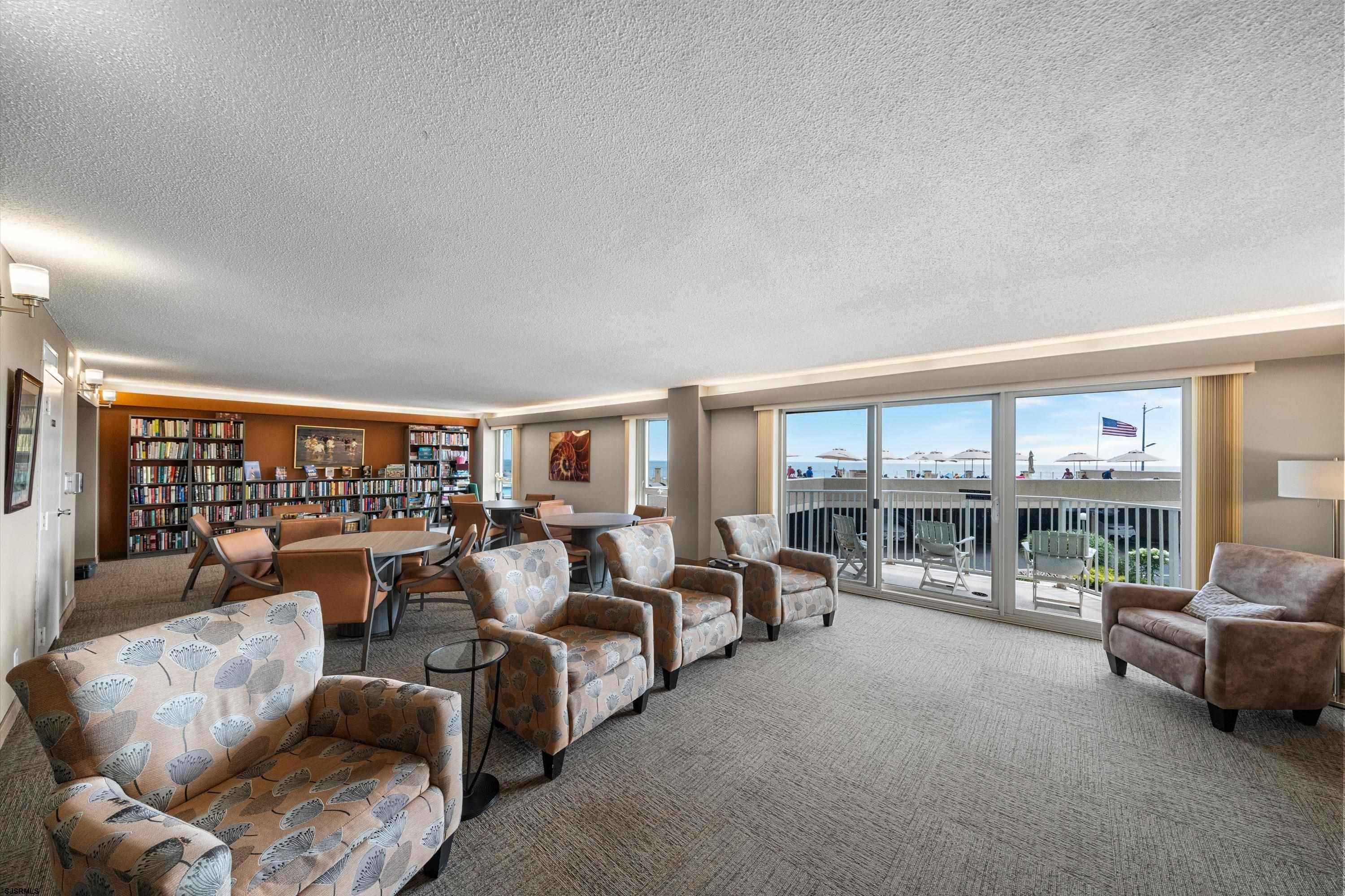 322 Boardwalk, Unit 1007 Ocean City, NJ 08226 - Photo 18 of 27 a living room with furniture and a floor to ceiling window