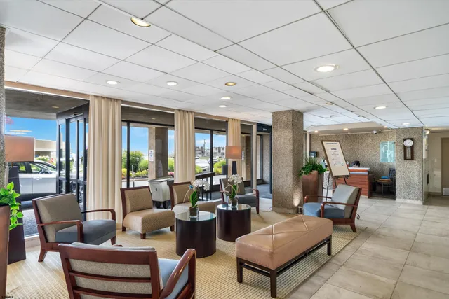 a living room with furniture and large windows