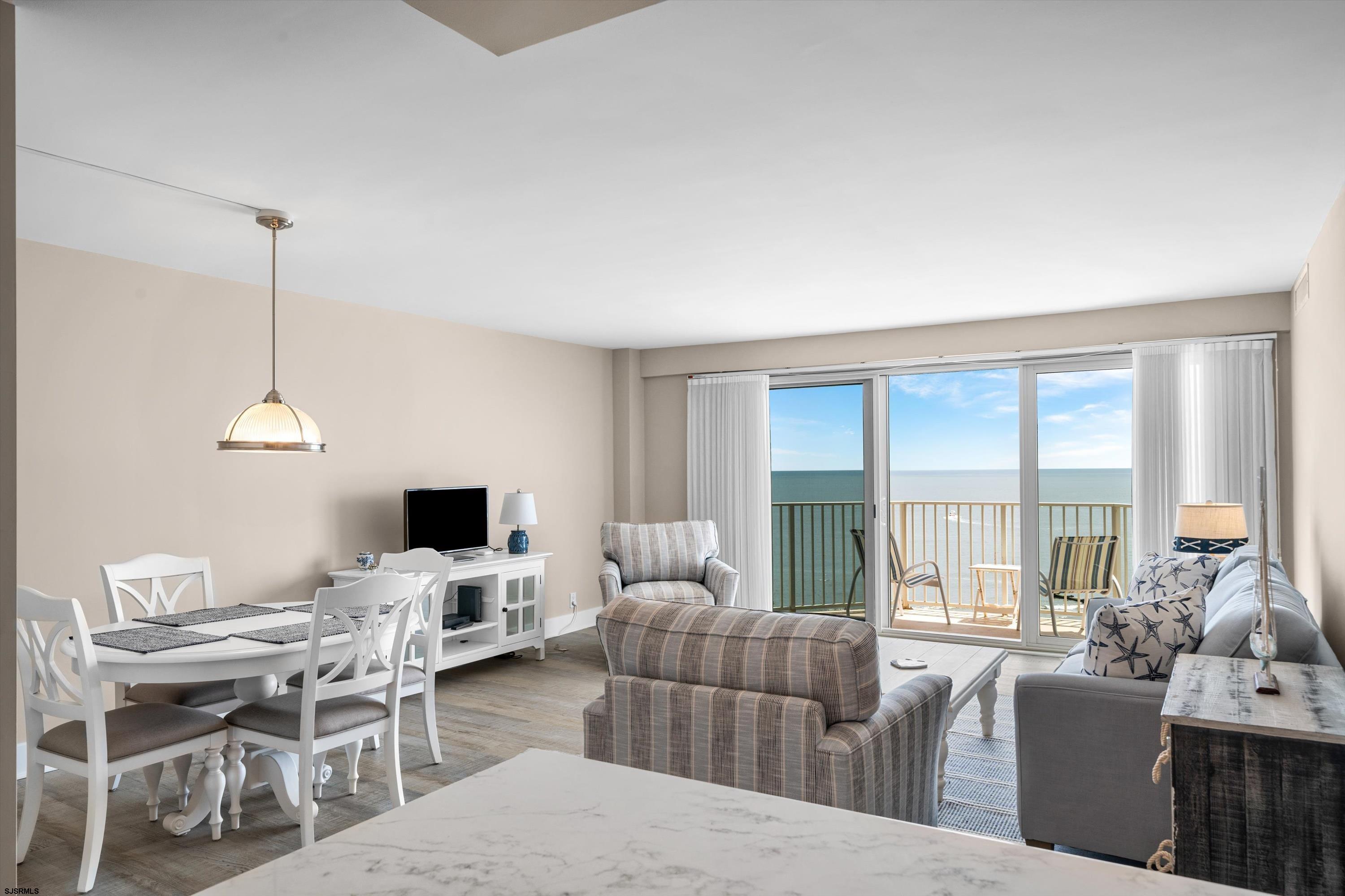 322 Boardwalk, Unit 1007 Ocean City, NJ 08226 - Photo 5 of 27 a living room with furniture and floor to ceiling windows
