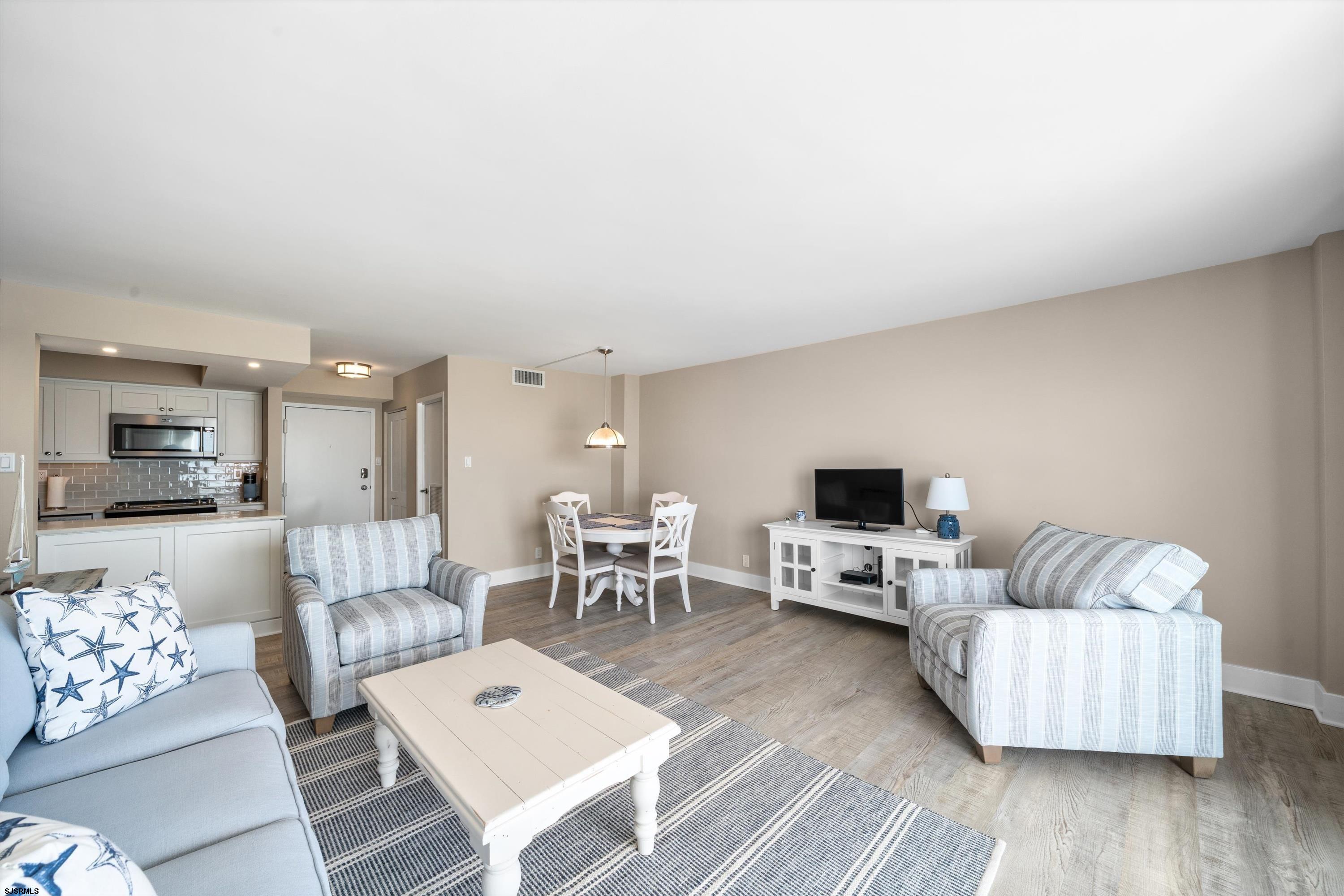 322 Boardwalk, Unit 1007 Ocean City, NJ 08226 - Photo 8 of 27 a living room with furniture and a flat screen tv