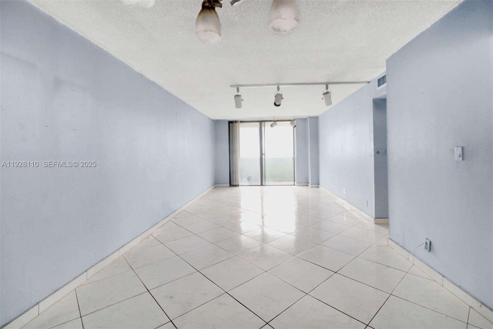 1825 West 44th Place, Unit 1111 Hialeah, FL 33012 - Photo 5 of 22 a view of an empty room with a window