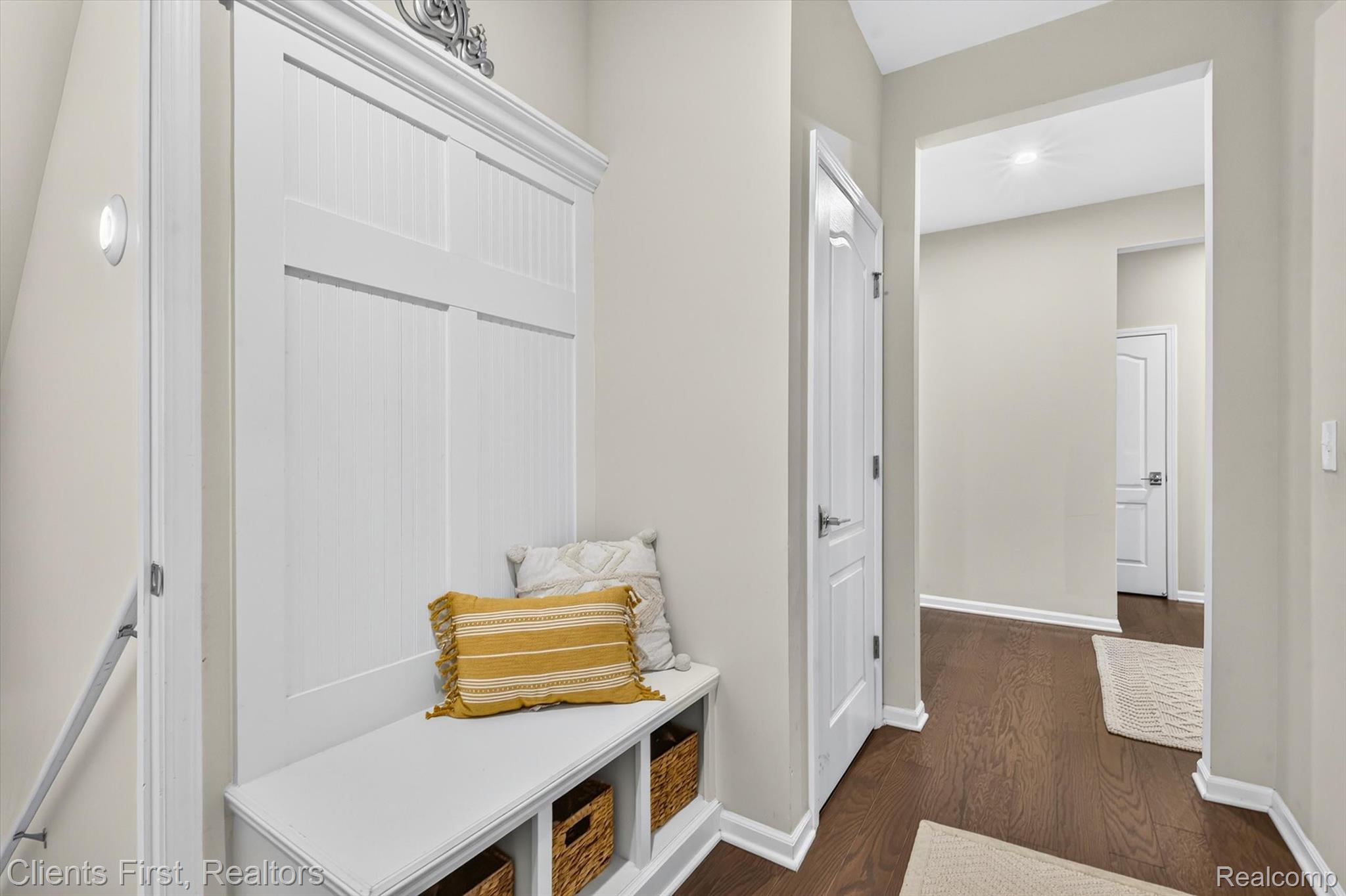4699 Bingham Road Canton, MI 48188 - Photo 31 of 47 Built-in mudroom bench with storage cubbies and paneling, dark wood-finish flooring, light neutral wall color, and white trim throughout