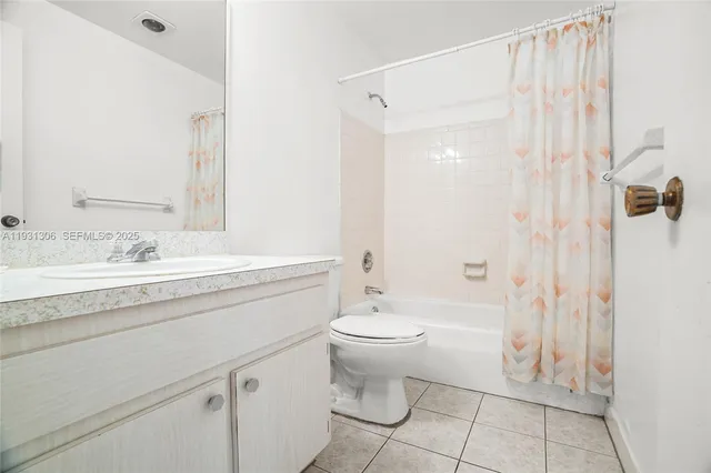 a bathroom with a granite countertop sink a toilet and shower