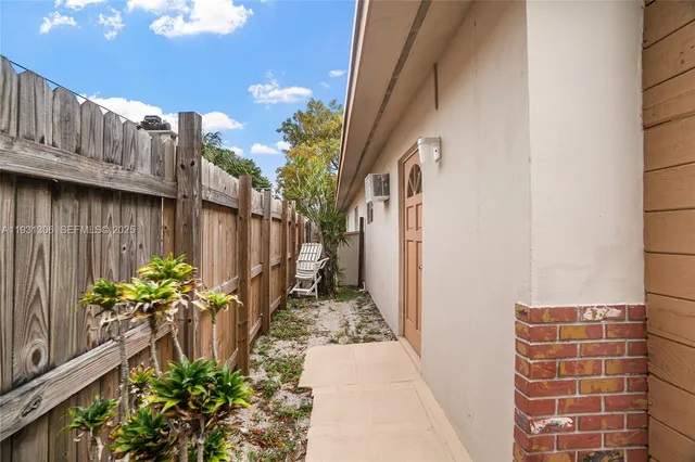 a vase with flowers on wooden floor